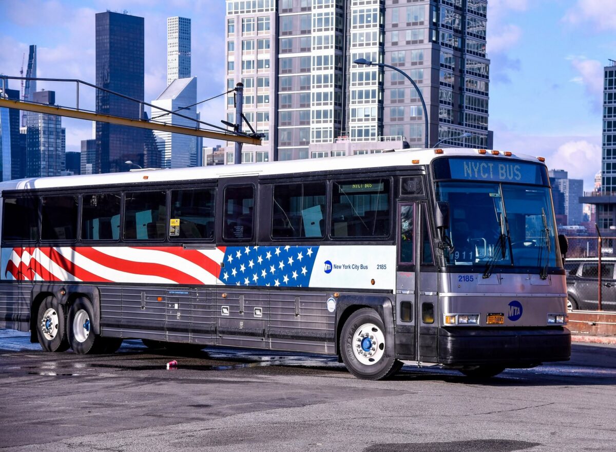 9/11 Memorial Bus 2185 with stars and stripes in a parking lot